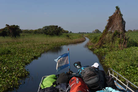 Tonle Sap lake, Cambodia - 13 January 2018: tourist boat navigating a tributary river to the Tonle Sap lake in Cambodiaのeditorial素材