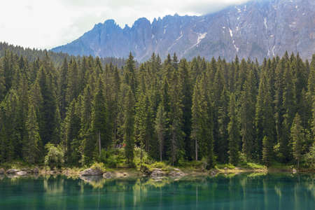 Lake Carezza with reflection of mountains in the Dolomites on South Tyrol, Italy.の写真素材