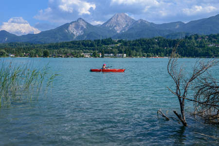 Lake Fakkar, Austria - 27 June 2018: woman on a canoe at lake Fakkar on Carinthia in Austriaのeditorial素材