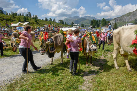 Engstlenalp, Switzerland - 4 August 2018: cow decorated with flowers and flags on the annual transhumance at Engstlenalp on the Swiss alpsのeditorial素材