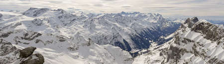 Winter landscape view from mount Titlis over Engelberg to the swiss alps