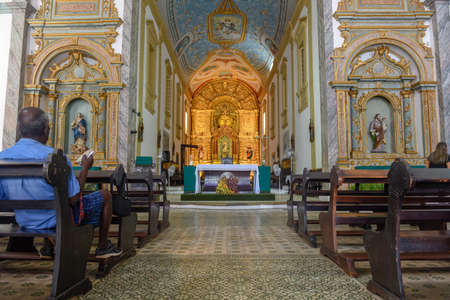 Sao Luis, Barzil - 15 January 2019: man praying on the cathedral Victoria at Sao Luis do Maranhao on...