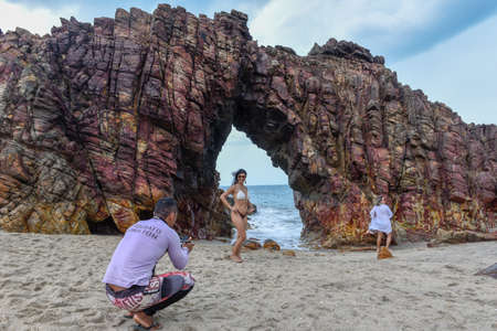 Jericoacoara, Brazil - 9 January 2019: people taking a souvenir photo in front of the natural arch of Jericoacoara on Brazilのeditorial素材