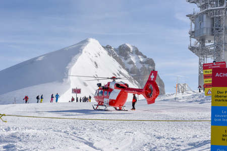 Engelberg, Switzerland - 3 March 2019: rescue helicopter on mount Titlis over Engelberg in the Swiss...