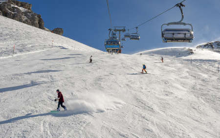 Engelberg, Switzerland - 3 March 2019: People skiing and going up the mountain by chairlift at Engelberg on the Swiss alpsのeditorial素材