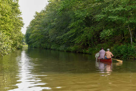 Vestbirk, Denmark - 18 June 2019: people rowing in a canoe on the river at Vestbirk, Denmarkのeditorial素材