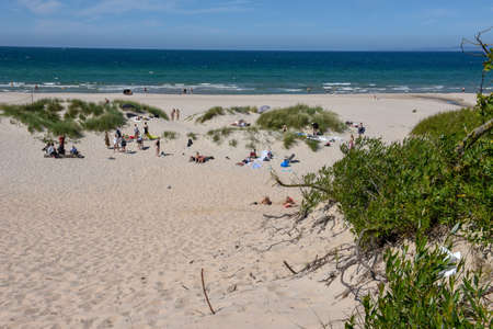 Hornbaek, Denmark - 28 June 2019: people sunbathing on the beach of Hornbaek in Denmarkのeditorial素材