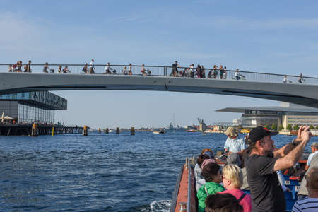 Copenhagen, Denmark - 25 June 2019: people riding bikes on the bridge in the center of Copenhagen,...