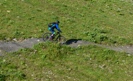 Jochpass, Switzerland - 4 august 2018: man on his mountain bike going down the path from Jochpass...