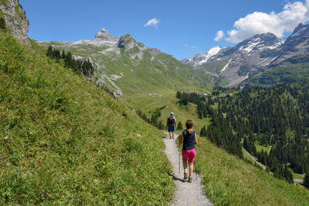 Engstlenalp, Switzerland - 4 August 2019: people hiking in the mountain path at Engstlenalp over Engelberg on the Swiss alpsのeditorial素材