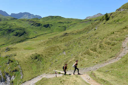 Engstlenalp, Switzerland - 4 August 2019: people hiking in the mountain path at Engstlenalp over Engelberg on the Swiss alpsのeditorial素材