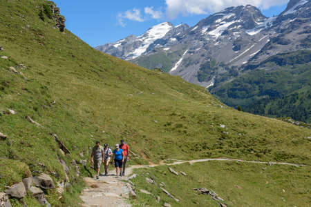 Engstlenalp, Switzerland - 4 August 2019: people hiking in the mountain path at Engstlenalp over Engelberg on the Swiss alpsのeditorial素材