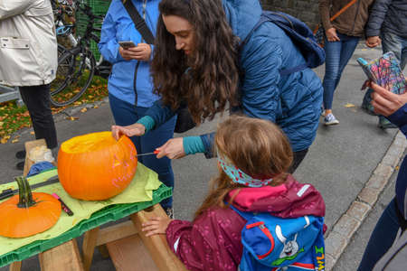 Engelberg, Switzerland - 28 September 2019: mom preparing a halloween mask to her daughter at Engelberg on the Swiss alpsのeditorial素材
