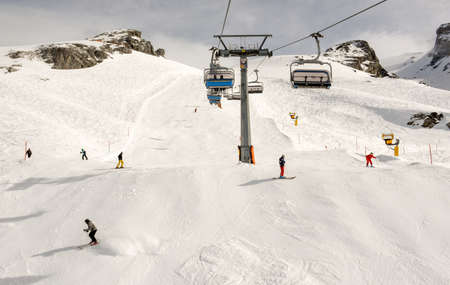 Engelberg, Switzerland - 3 March 2019: People skiing and going up the mountain by chairlift at Engelberg on the Swiss alpsのeditorial素材