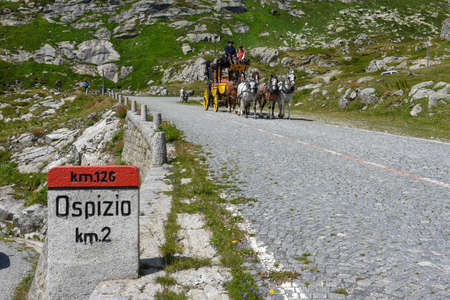 Mount Gotthard, Switzerland - 3 August 2019: horse drawn carriage along the old road of Mount Gotthard on the Swiss alpsのeditorial素材