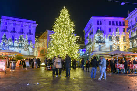 Lugano, Switzerland - 11 December 2019: people shopping on the christmas market in the central square of Lugano, Switzerlandのeditorial素材