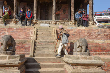 Patan, Nepal - 24 January 2020: people sitting on the temple of Durban square at Patan near Kathmandu in Nepalのeditorial素材