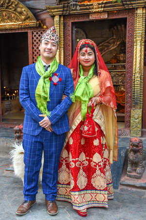 Patan, Nepal - 24 January 2020: wedding couple on traditional clothes at a temple of Patan near Kathmandu in Nepalのeditorial素材