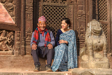 Bhaktapur, Nepal - 28 January 2020:   beautiful woman with old man on traditional clothes at Bhaktapur in Nepalのeditorial素材