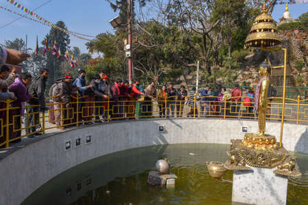 Kathmandu, Nepal 7 January 2020: people throwing coins into the fountain of Swayambhunath temple at Kathmandu on Nepalのeditorial素材