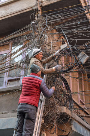 Kathmandu, Nepal - 7 January 2020:    workers reparing a multitude of entangled electrical cables at Kathmandu on Nepalのeditorial素材