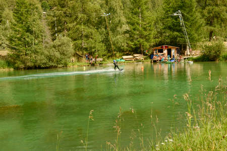 Tasch, Switzerland - 18 July 2020: man practicing wakeboard on the lake at Tasch in the Swiss alpsのeditorial素材