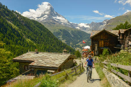 Zermatt, Switzerland - 19 July 2020: man driving a mtb on a trail at Zermatt on the Swiss alpsのeditorial素材