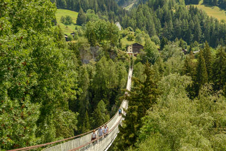 Niederwald, Switzerland - 23 July 2020: people walking on the tibetan suspended bridge near Niederwald on the Swiss alpsのeditorial素材