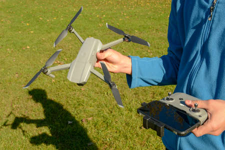 Lugano, Switzerland - 25 Oktober 2020: boy with a drone and his remote control