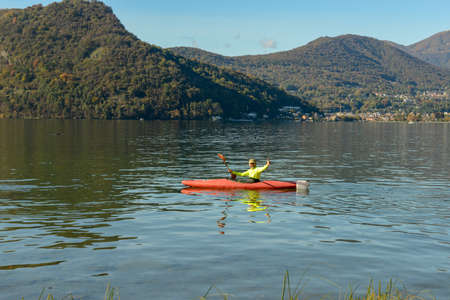 Lugano, Switzerland - 25 Oktober 2020: man who is rowing in his canoe on lake of Lugano in Switzerlandのeditorial素材