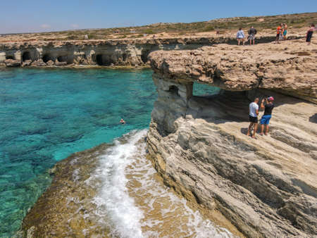 Ayia Napa, Cyprus - 12 May 2021: people visiting the coast with caves near Ayia Napa on Cyprusのeditorial素材