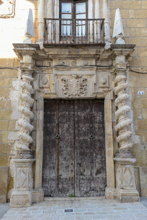 Old entrance door at Osuna on Andalusia in Spainの写真素材