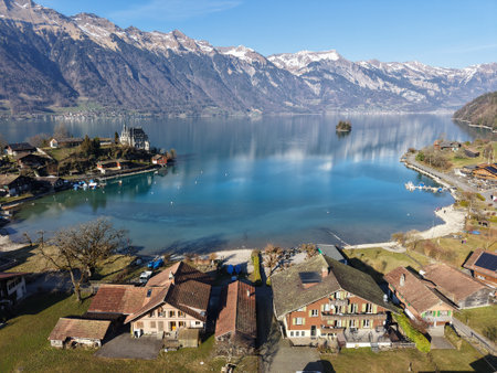 Drone view at the village of Iseltwald on lake Brienz in the swiss alpsの写真素材