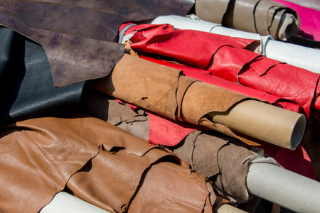 Rolls of leather and hides on display, handcrafted material used for leather goods, fashion, and...