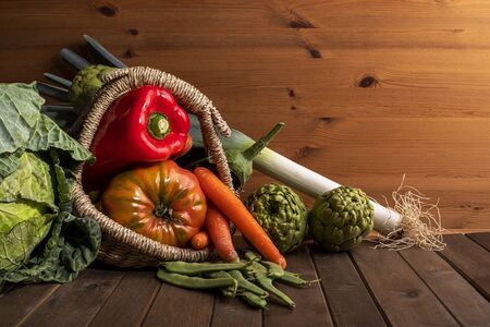 Still life of vegetables from the garden on wooden table and black backgroundの写真素材