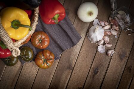 Organic food vegetables in wicker basket on rustic wooden table. Zenith view.の写真素材