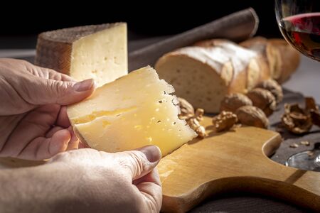 Manchego cheese on wooden table.の写真素材