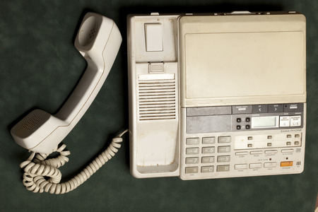 vintage phone with handset and answering machine on green velvet,the handset lies nextの写真素材