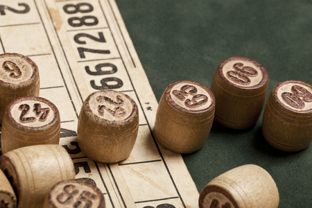 Table game Bingo. Wooden Lotto barrels with bag, playing cards for Lotto games, games for family on...