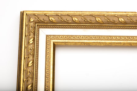 A decorative golden picture frame with intricate leaf patterns. The frame is designed for displaying...