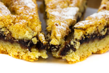 Tasty cake with powder sugar on top and plum stuffの写真素材