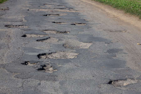 road full of holes in the asphalt. Bumpy.の写真素材