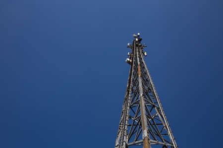 Mast of the cellular network over the blue sky
