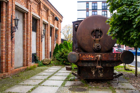 an old rusty spark-free locomotive standing on the promenade in Å»yrardÃ³w