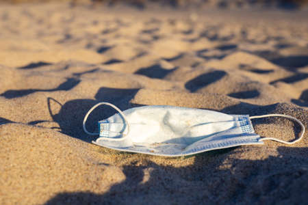 Worn Covid masks on the beach