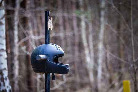 A roadside cross with a motorcycle helmet commemorating the tragic death of a motorcyclist. Made on a cloudy day, soft, soft light.の写真素材