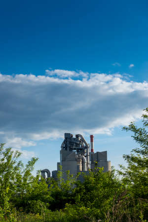Cement plant on the background of the blue sky. Well visible industrial installations. Perfect, natural lighting conditionsの写真素材
