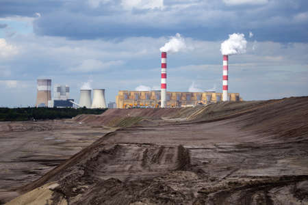 A view of a lignite-fired power plant against the background of an opencast coal mine. Photo taken...