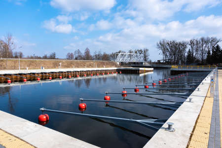 Empty yacht port, parking boxes with red buoys. Made at noon on a sunny day. City of Pisz, Polandの写真素材