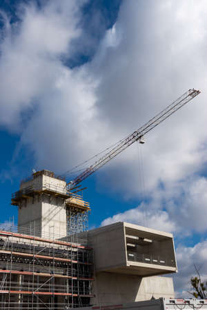 Construction crane on the construction site of a public facility. Grodzisk Mazowiecki, Poland. Photo...